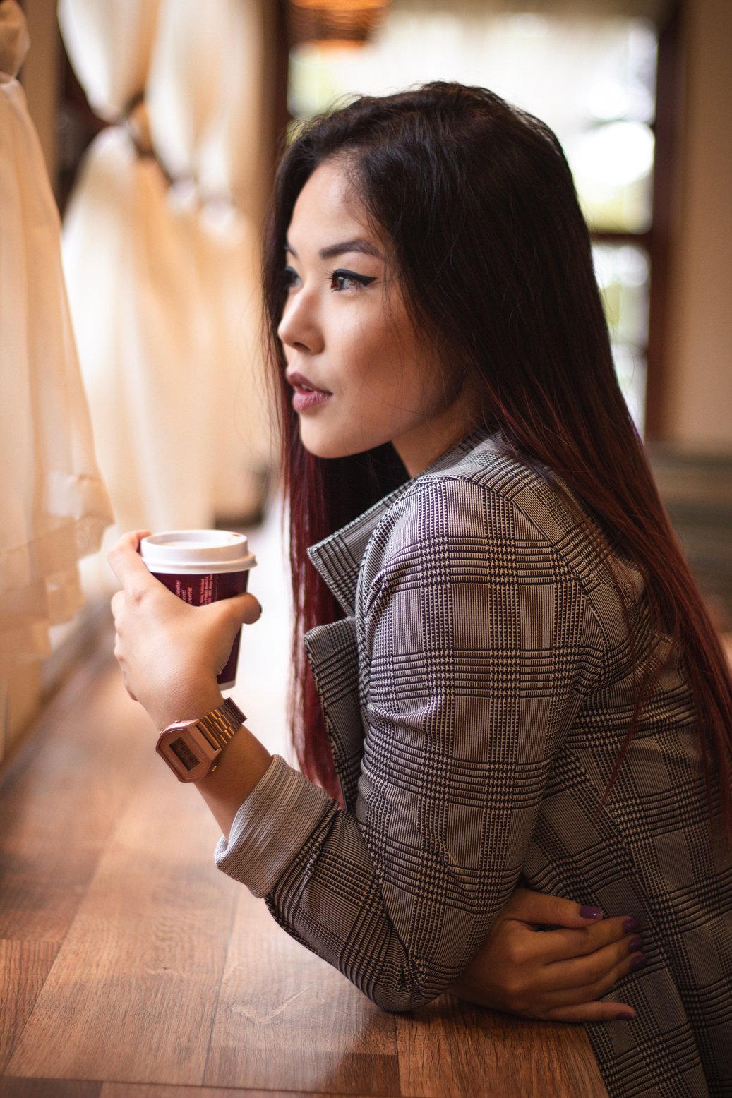 Woman Leaning on Table Holding Cup